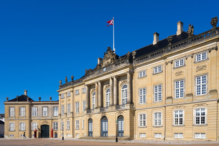 Guard walks in front of the Amelienborg Palace in the Danish capital city Copenhagen. It is a residence of the Danish royal family.