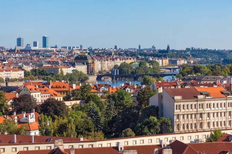 The view from the Opyš Hill towards the Vltava in Prague, Czechia. The bridge in the center of the frame is called the Legion Bridge (Czech: Most Legií). The big brown building with a dome-like roof is the Czech National Theater (Národní divadlo).